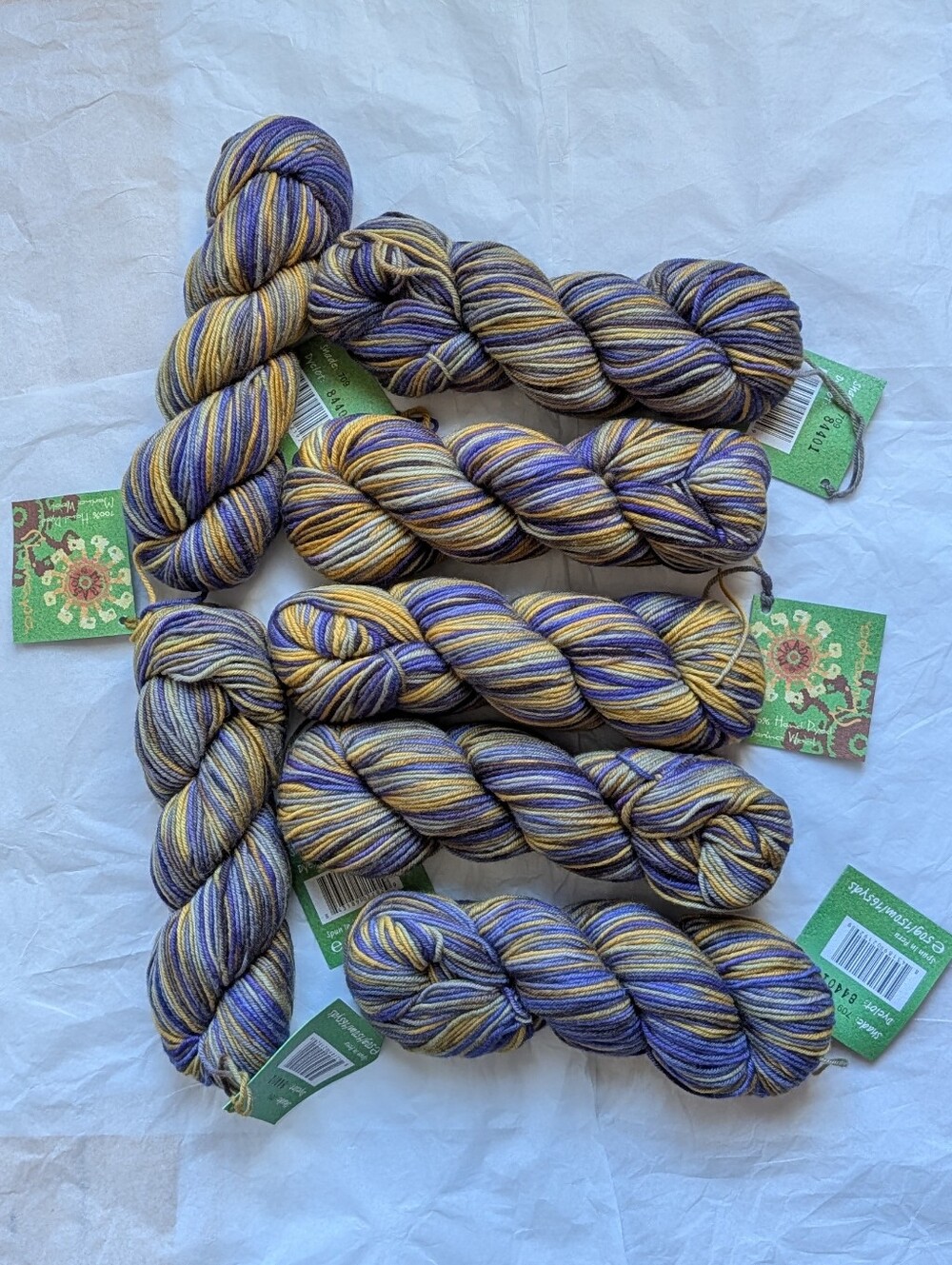 7 skeins of purple and yellow variegated yarn, 100% hand dyed Merino Wool
